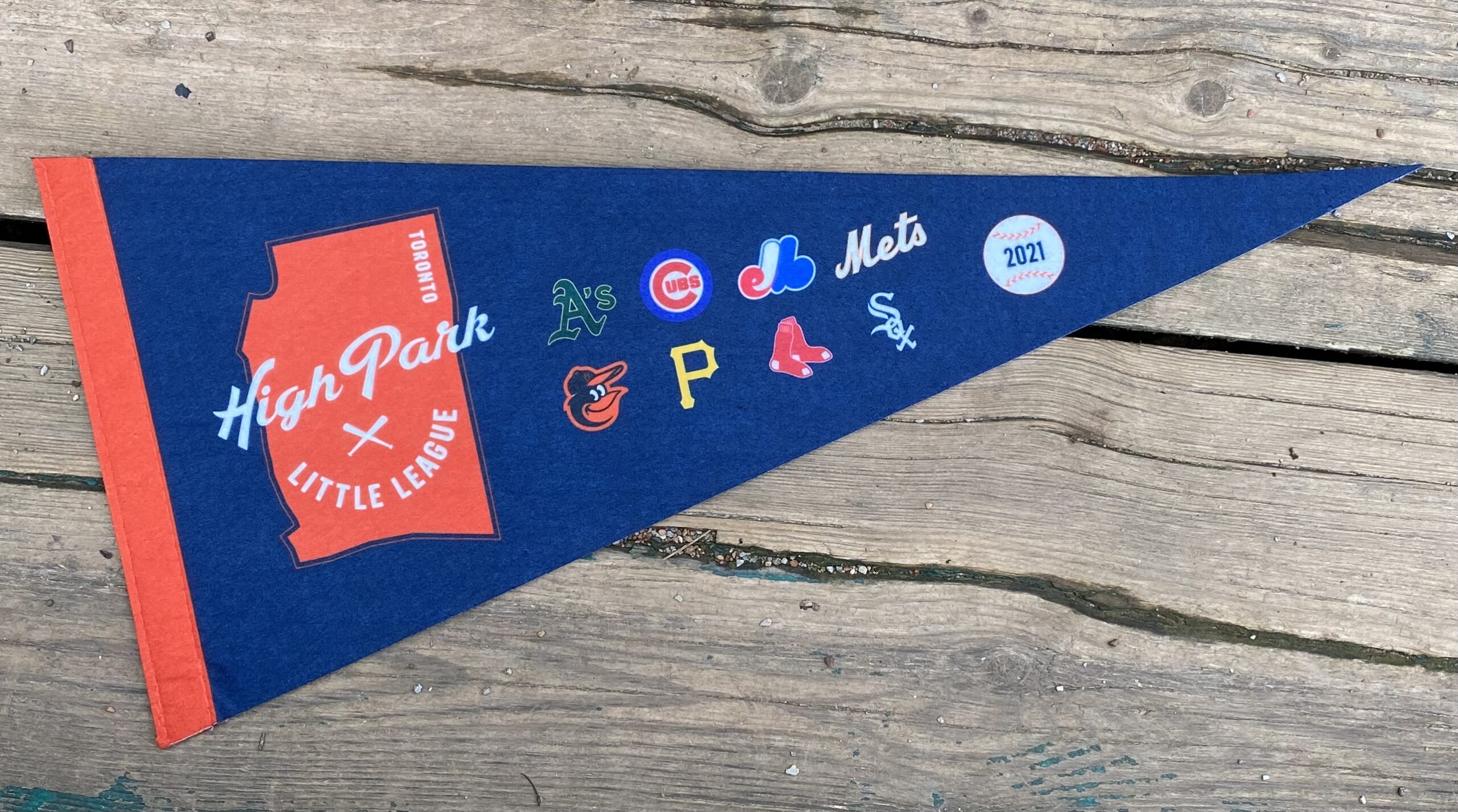 Photo of a blue pennant with logos of league and each majors team.